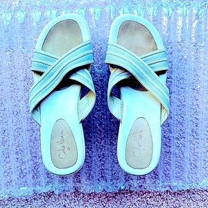 Cole Haan and Nike Air white slip on sandals.